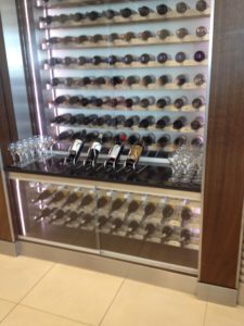 a wine rack with wine glasses and bottles