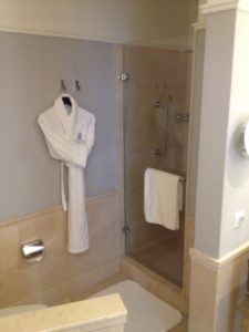a bathroom with a bathrobe and shower