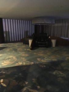 a room with a carpet and a lamp