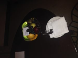 a plate of fruit and fork on a table