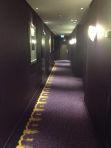 a hallway with purple carpet and lights