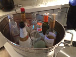 a bucket of bottles in a kitchen