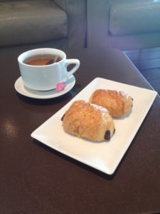 a plate of pastries and a cup of tea