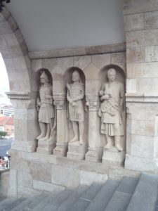 a stone statues of men in a row