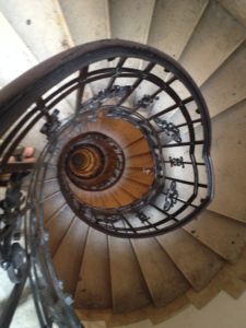 a spiral staircase with a circular staircase