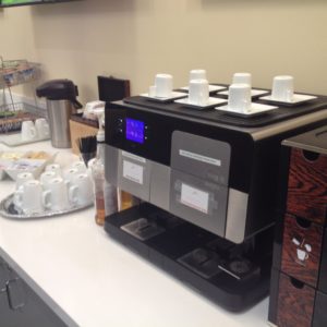 a coffee machine with cups on top
