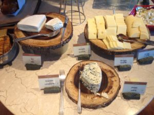 a table with plates of cheese and forks