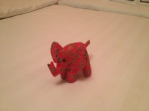 a red elephant on a bed