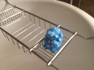 a blue toy in a metal rack