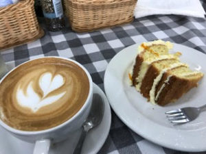 a plate of coffee and a slice of cake