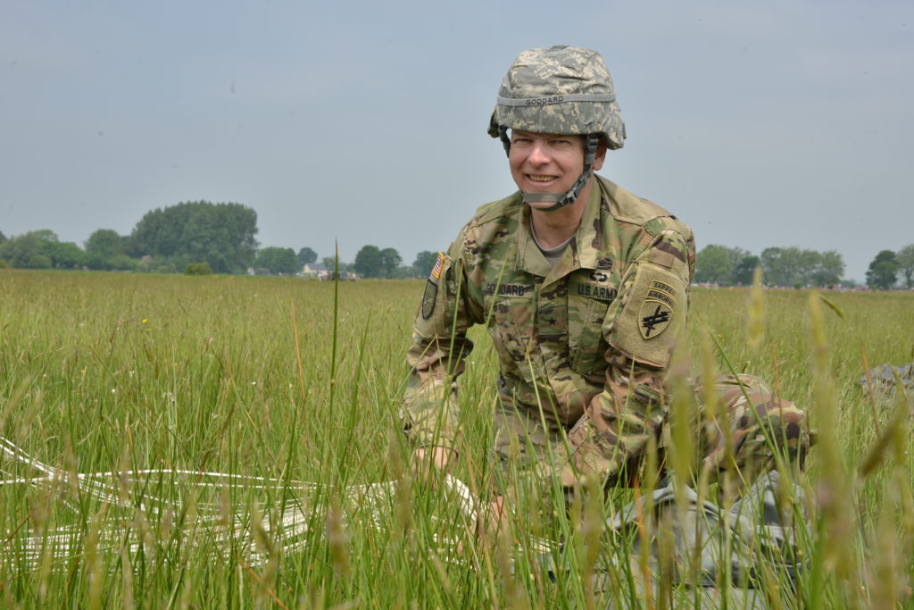 a man in military uniform in a field