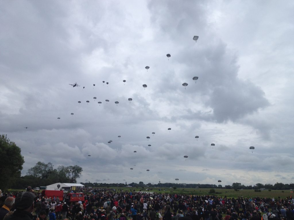 a group of people in the sky with parachutes