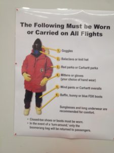 a sign with a person wearing a mask and gloves