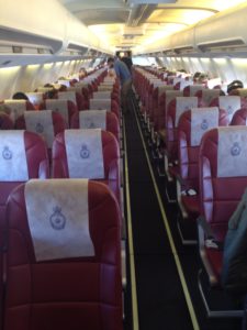 a row of red and white seats on an airplane