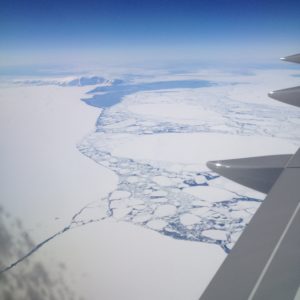 an aerial view of an iceberg and land