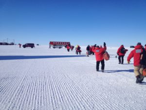a group of people in red jackets on a snowy field
