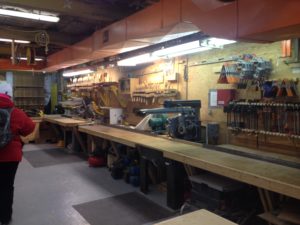 a workshop with many workbenches and tools