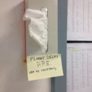 a box of tissues with a note on the wall